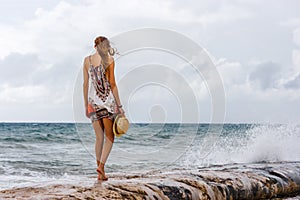 Woman staring at the sea at Playa del Carmen beach, Quintana Roo, Mexico.