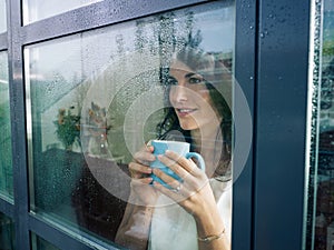 Woman staring at the window photo