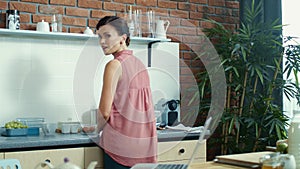 Woman starting video call on notebook. Girl saying hello on laptop camera.