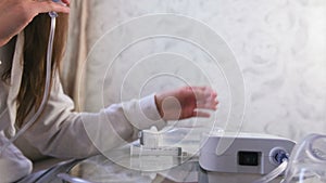 Woman starts the inhalation procedure, hands close-up.