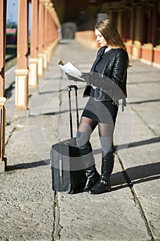 Woman at station explore country route map