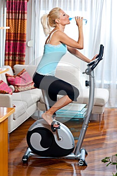 Woman on stationary bicycle