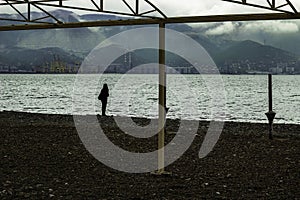 Woman stay near the sea coastline on the beach photo