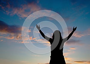 Woman staying with raised hands