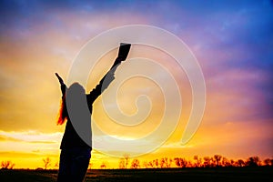 Woman staying with raised hands