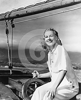 Woman steering sailboat