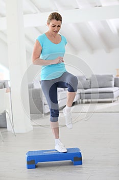 Woman step excercising at home