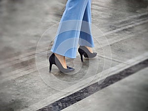 Woman step legs wearing black high heels shoes