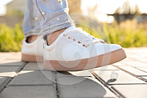 Woman stepping in chewing gum on sidewalk