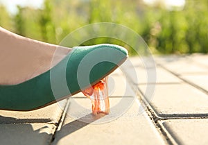 Woman stepping in chewing gum on sidewalk