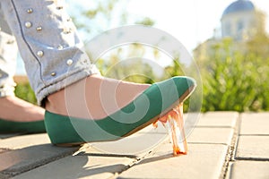 Woman stepping in chewing gum on sidewalk