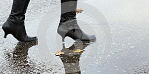 Woman stepping into a pool of water