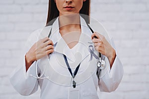 Woman with Stethoscope in Clinic. Happy Nurse. photo