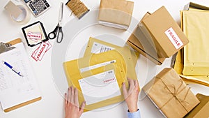 Woman sticking fragile marks at post office