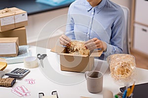 Woman sticking fragile marks at post office