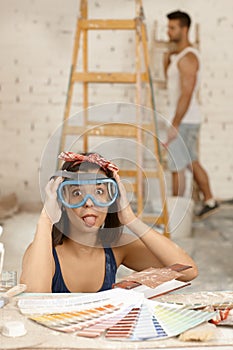 Woman sticking tongue at home renewal