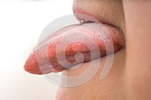 Woman is sticking tongue out. on white background