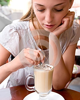 Woman is stirring coffee