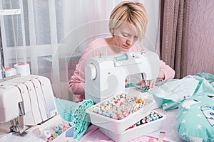 Woman stitch at home on sewing machine