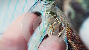 Woman stitching embroidery. Hands with needle sewing embroidery. Vertical video