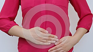 Woman stomach ache. Woman having a stomachache, or menstruation pain with white background. Health care and medical