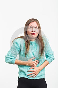 Woman with stomach pain on blue background
