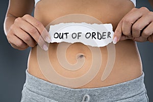 Woman With Stomach Pain Showing Out Of Order Sign