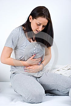 Woman stomachache in bed