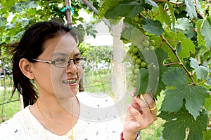 Woman stood by grape