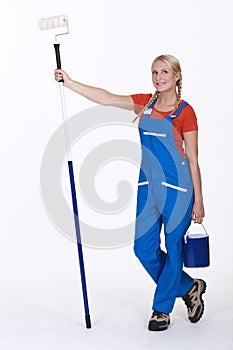 Woman stood with paint roller