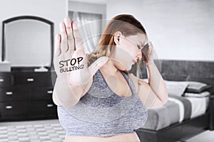 Woman with stop bullying word in hand
