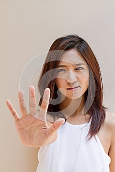 Woman with stop, reject, refuse, forbid, negative hand sign photo