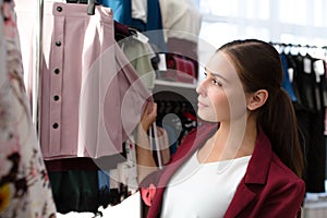 Woman in a store chooses clothes. woman shopping