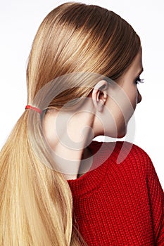 Woman with Straight Blond Hair, Tied in Ponytail, Wearing Red Knitted Pullover. Beautiful Gold Hair in Pony Tail