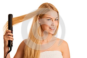 Woman straighten her hait isolated over white background