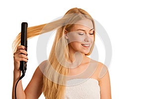 Woman straighten her hait isolated over white background