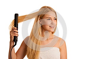 Woman straighten her hait isolated over white background