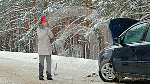 Woman with a straw car on the road in winter