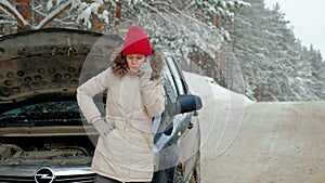 Woman with a straw car on the road in winter