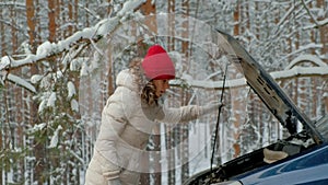 Woman with a straw car on the road in winter
