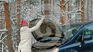 Woman with a straw car on the road in winter