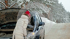 Woman with a straw car on the road in winter