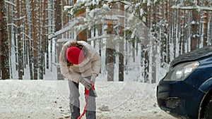 Woman with a straw car on the road in winter