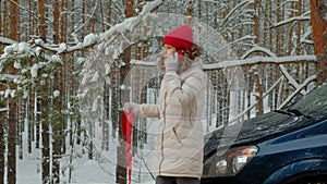 Woman with a straw car on the road in winter