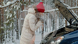 Woman with a straw car on the road in winter