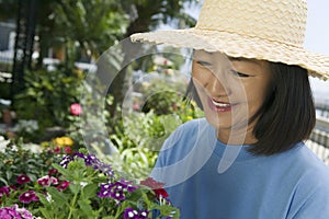 Woman in straw hat gardening