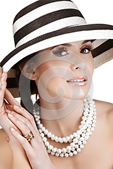 Woman in straw hat and pearls