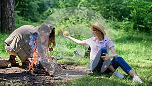 Woman straw hat sit meadow hold apple fruit. Healthy life is her choice. Girl enjoy picnic with healthy snack apple