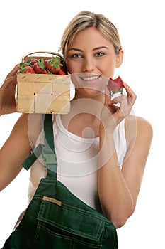 Young woman with box of strawberries