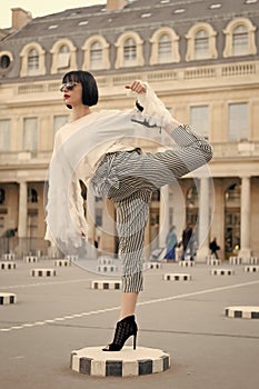 Woman stretch leg on square in paris, france